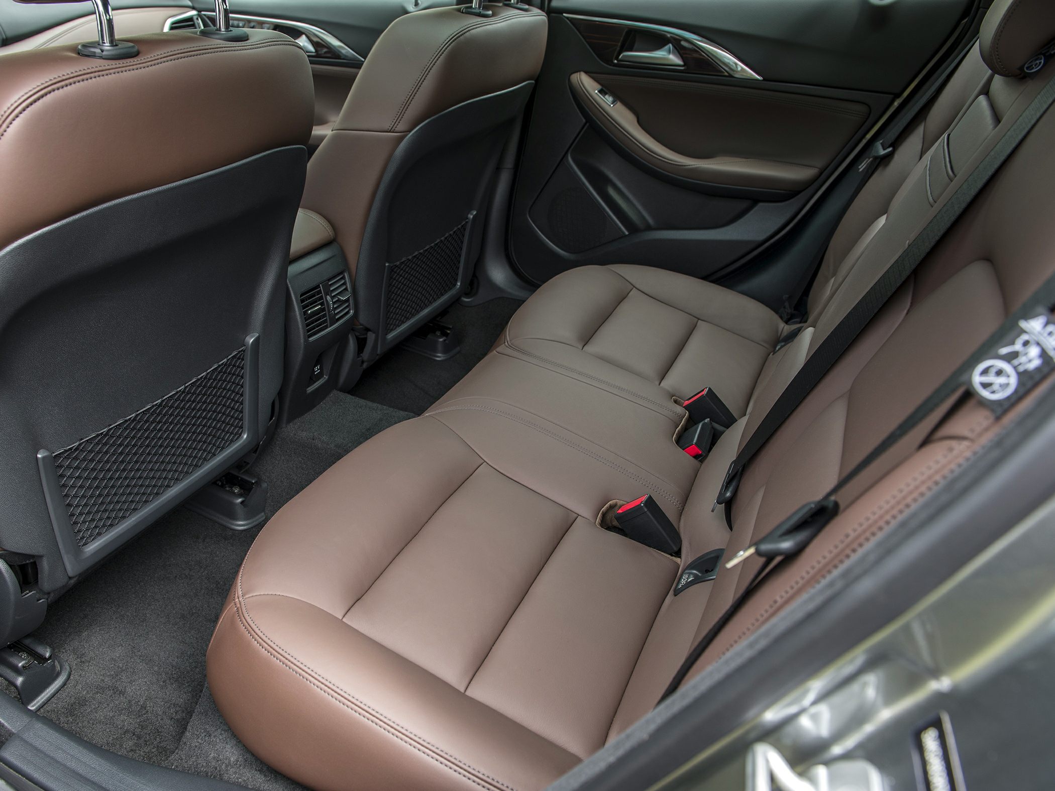 Brown leather rear seats with spacious legroom and safety belts
