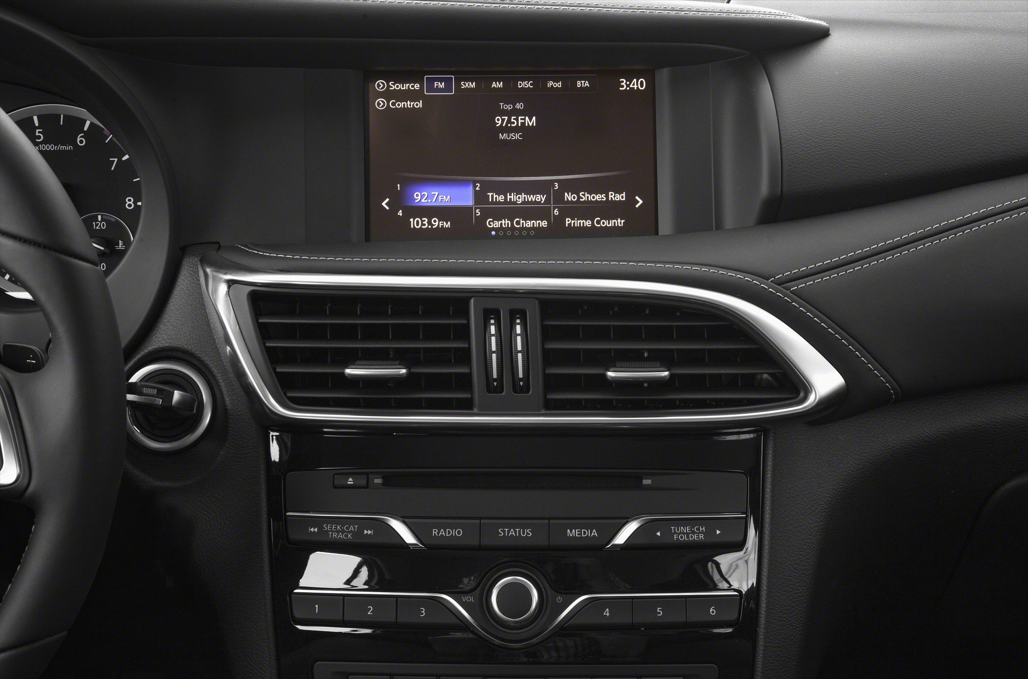 Car dashboard with touchscreen infotainment and central air vents