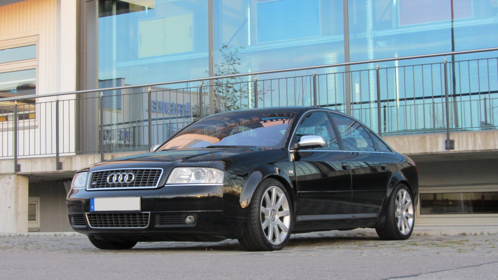 Black sedan with distinct grille and alloy wheels front side view