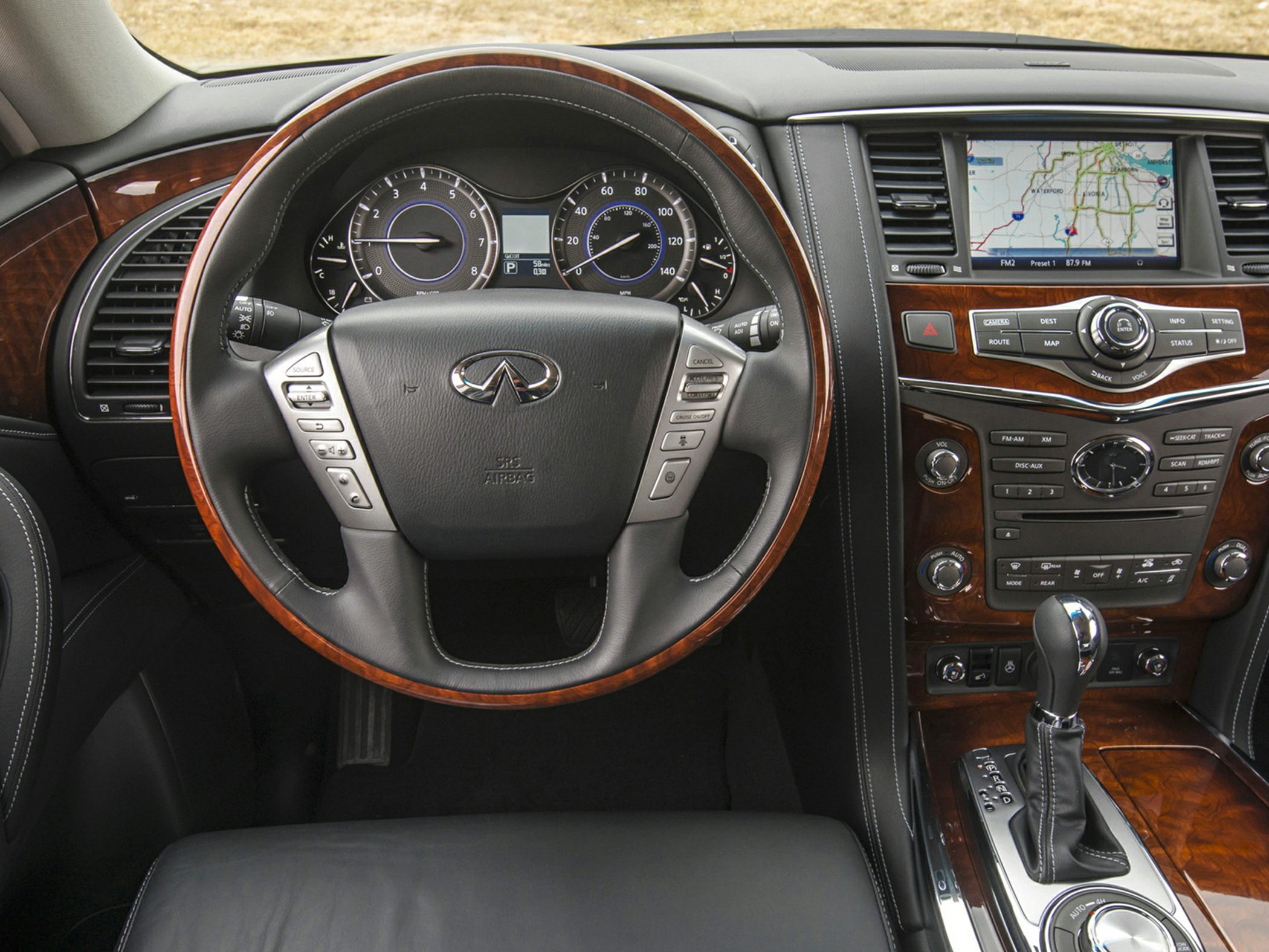 Wood-trimmed steering wheel, navigation display, premium wood console