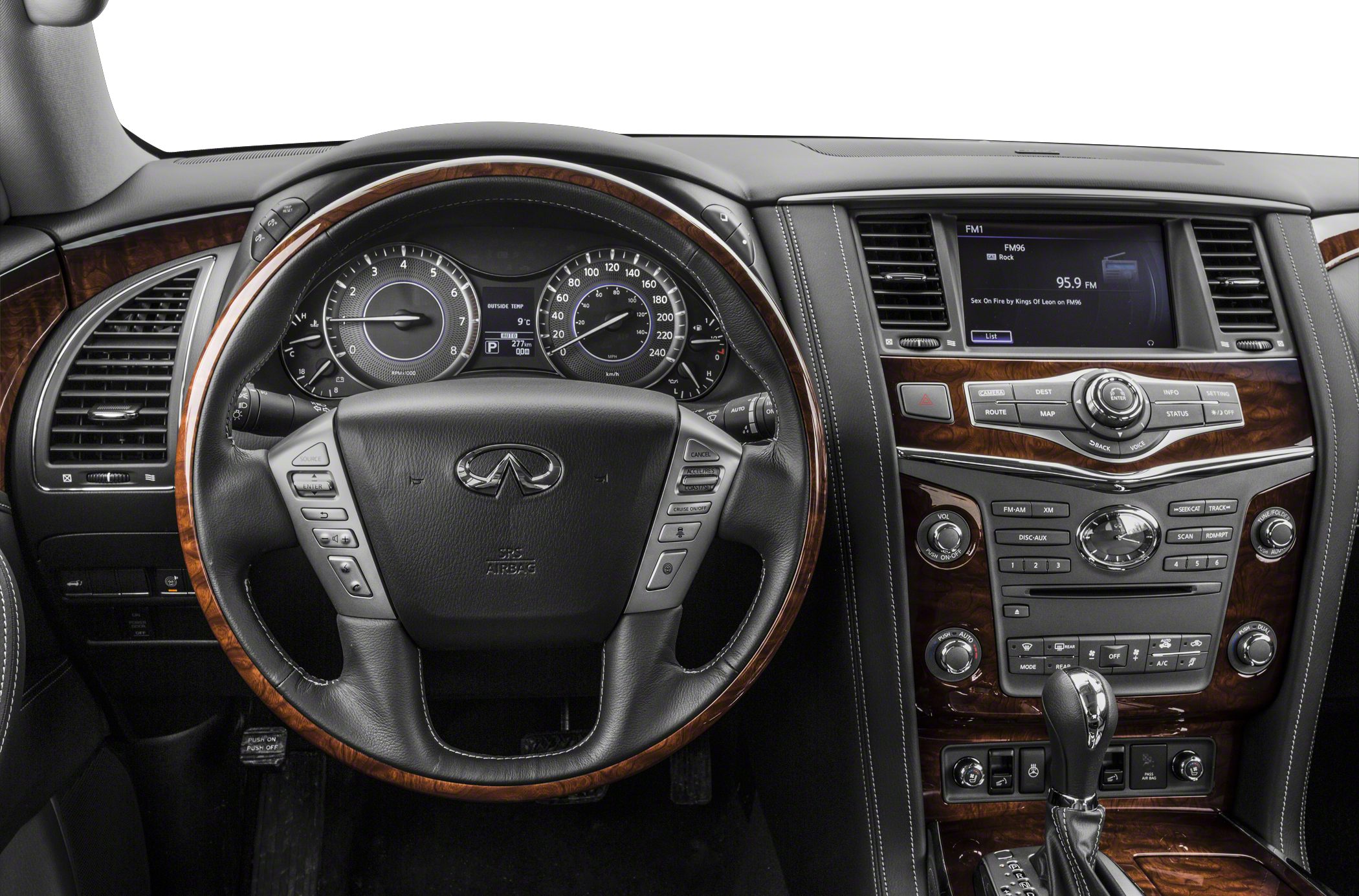 Wood-trimmed steering wheel and detailed center console with infotainment and controls