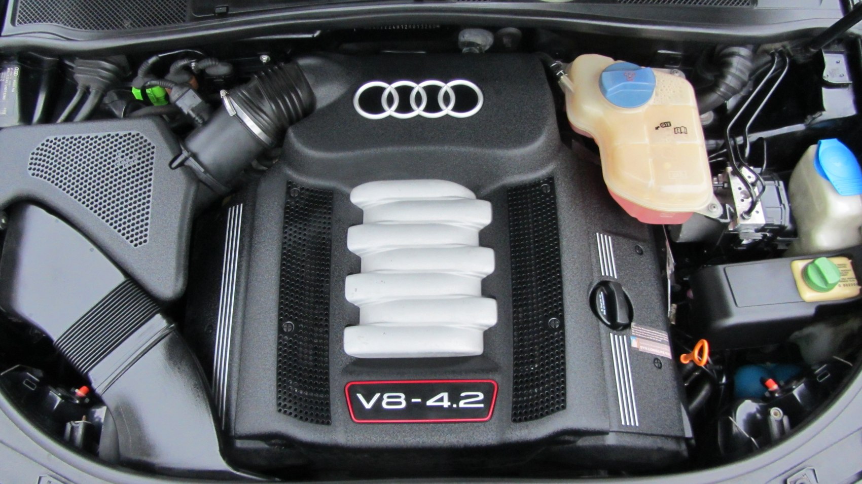 Close-up of a 4.2L V8 engine with Audi rings on the cover