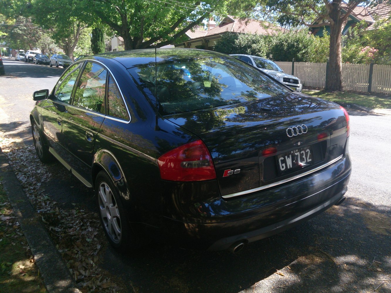 Rear side view of sedan with taillights and alloy wheels