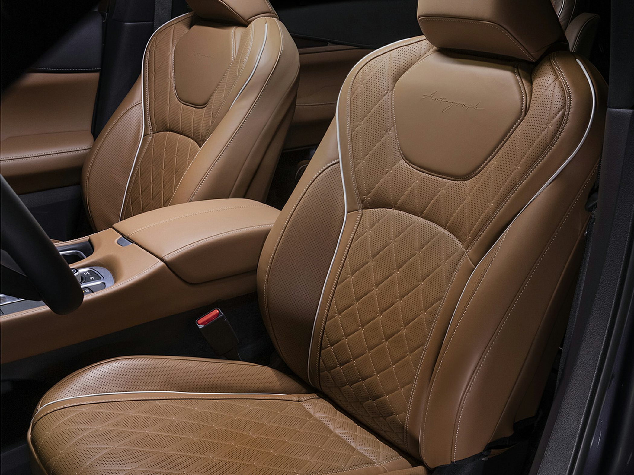 Brown perforated leather seats with diamond stitching and armrest