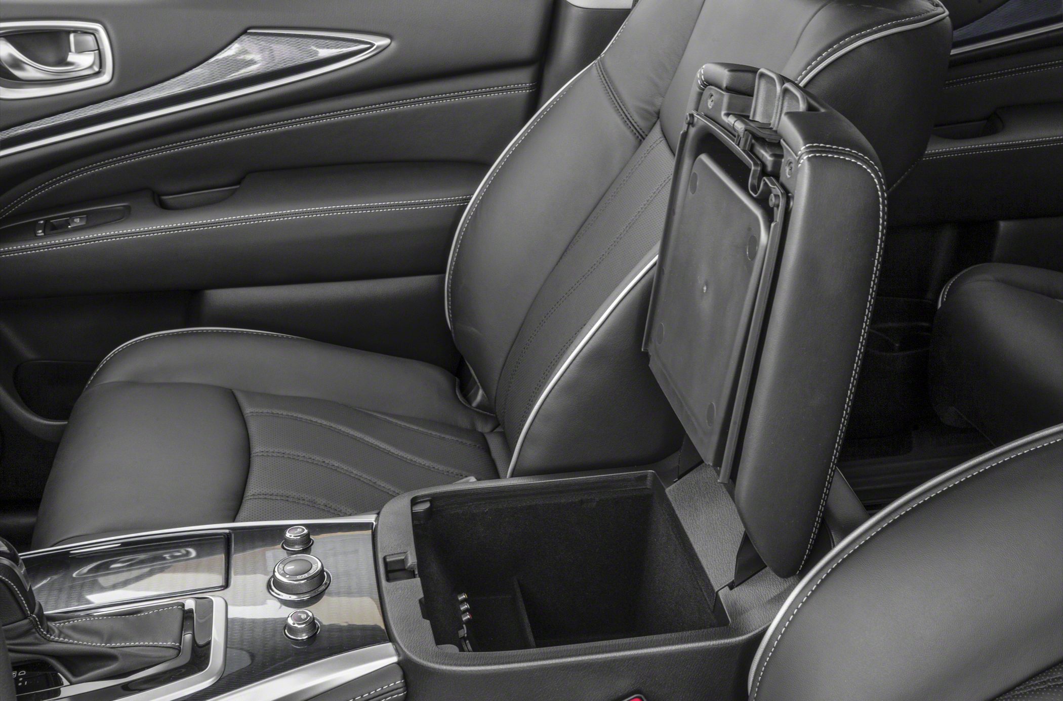 Leather seat with white stitching and open center console storage compartment