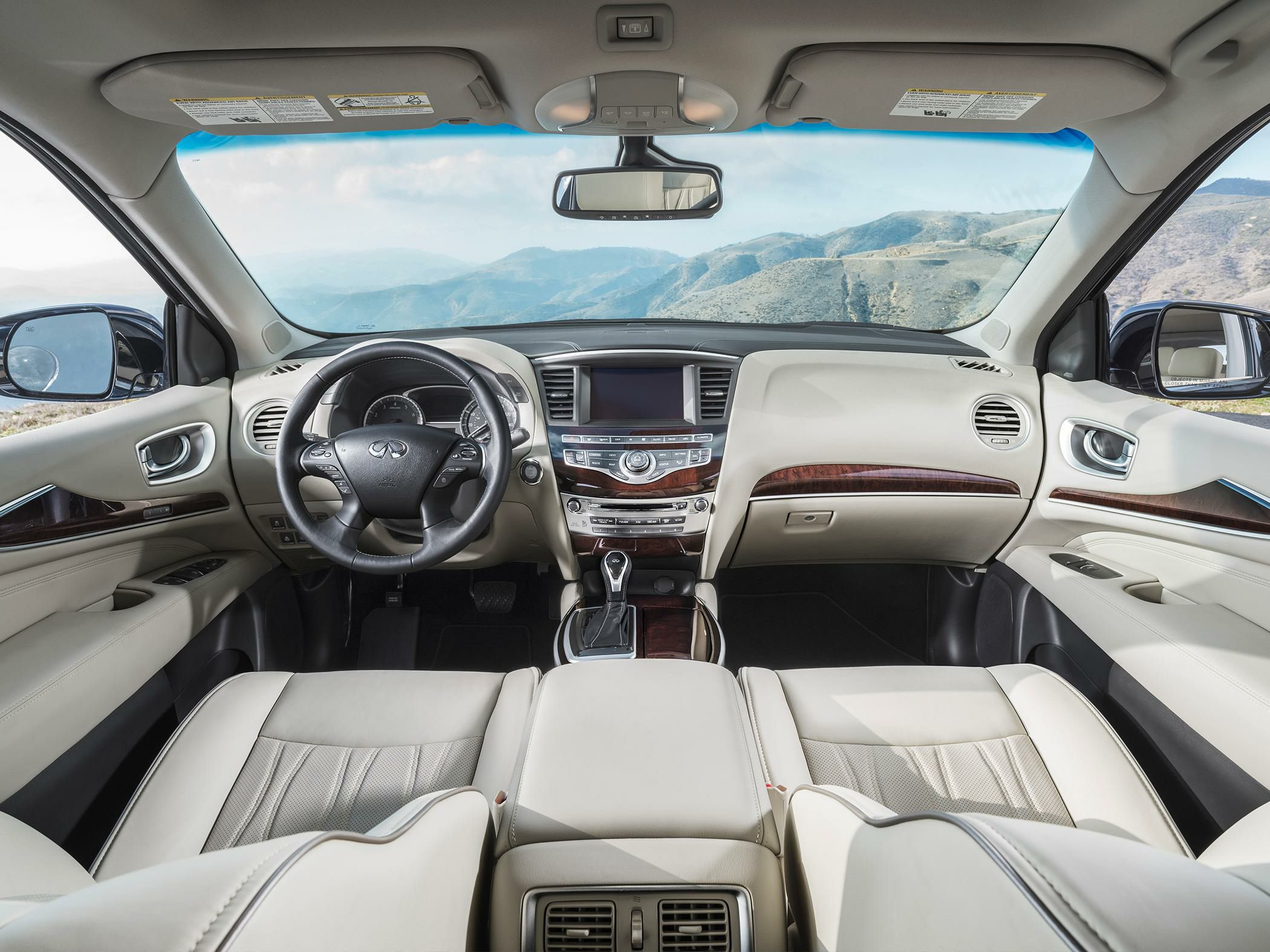 Beige leather interior with wood trim and advanced infotainment controls