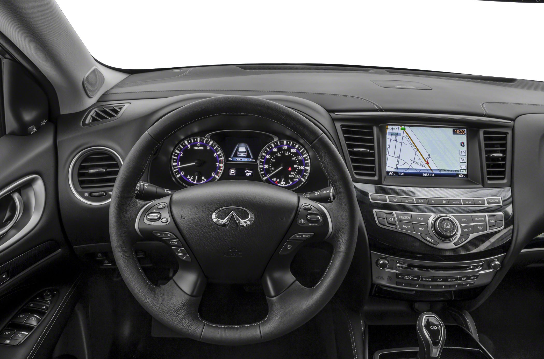 Steering wheel with controls, dashboard with analog gauges, navigation screen