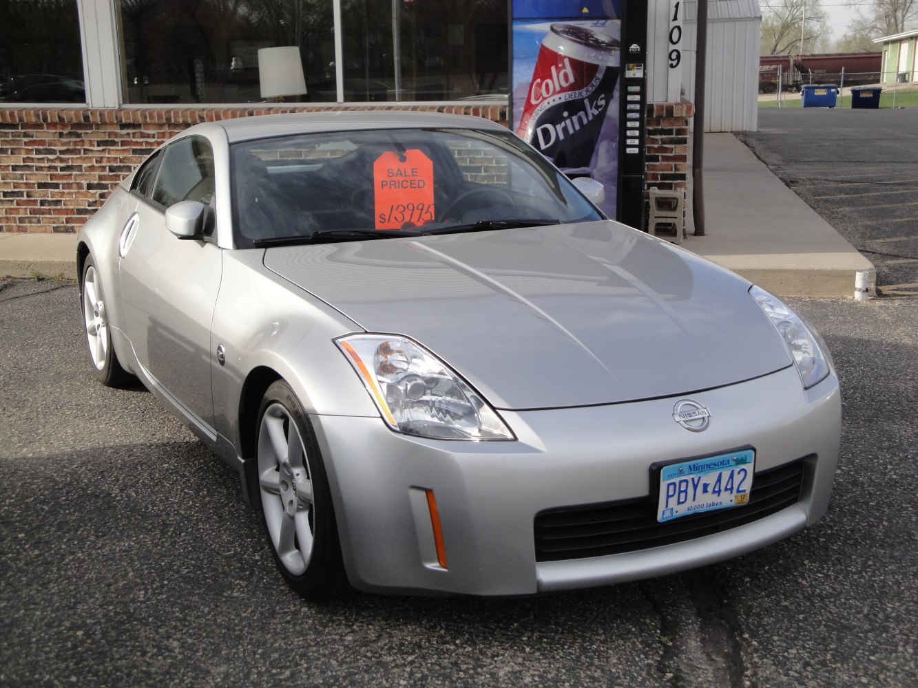 Silver sports coupe front view with aerodynamic design and sharp headlights.