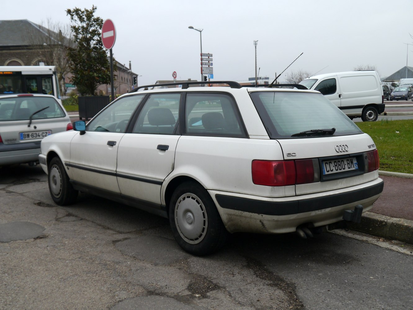 Rear side view of a 90s estate car with clean lines and roof rails