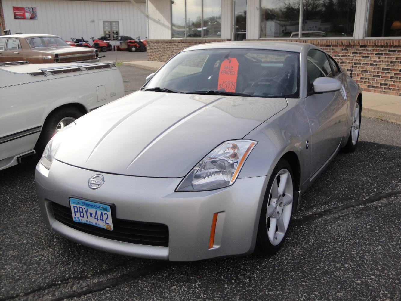 Silver sports coupe front view with headlights and sleek design