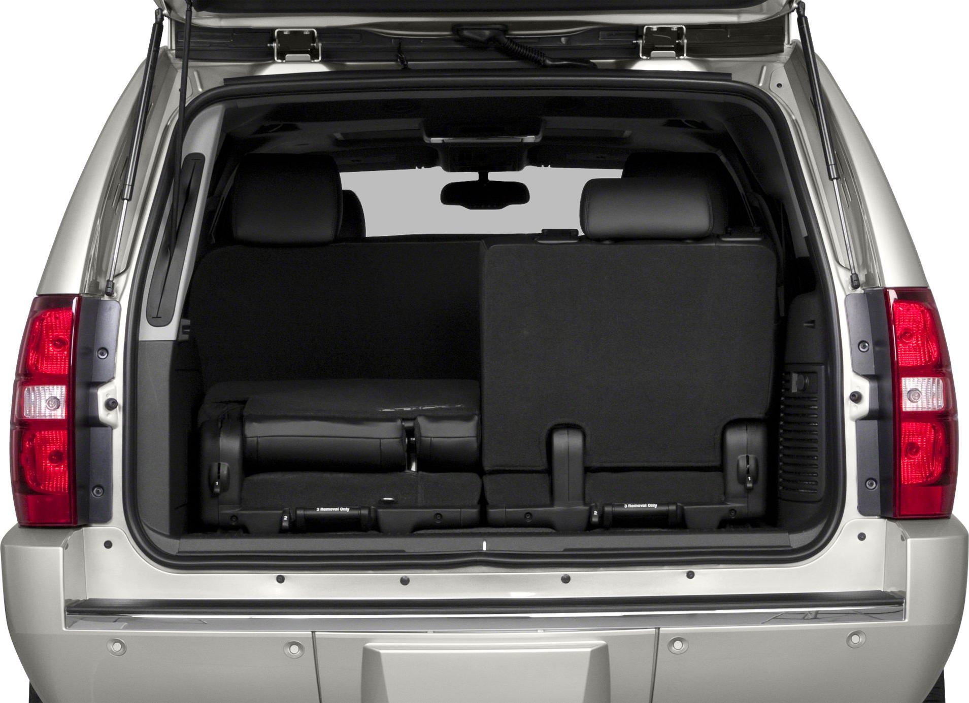 Rear cargo area with folding third-row seats and visible tailgate hinges