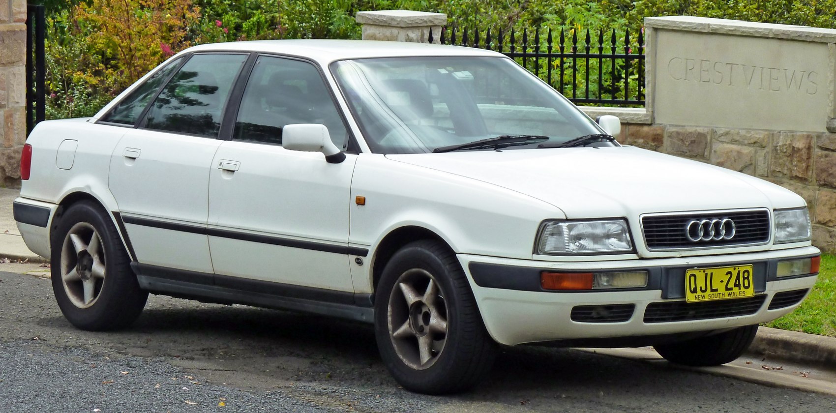 Front side view of a vintage sedan with distinct grille and alloy wheels