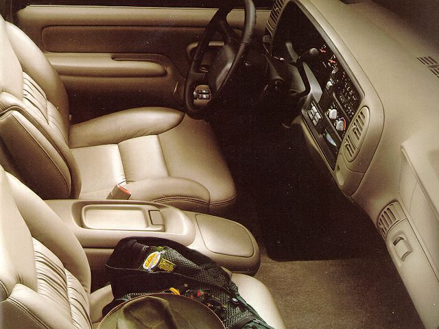 Tan leather seats, center armrest, and dashboard layout