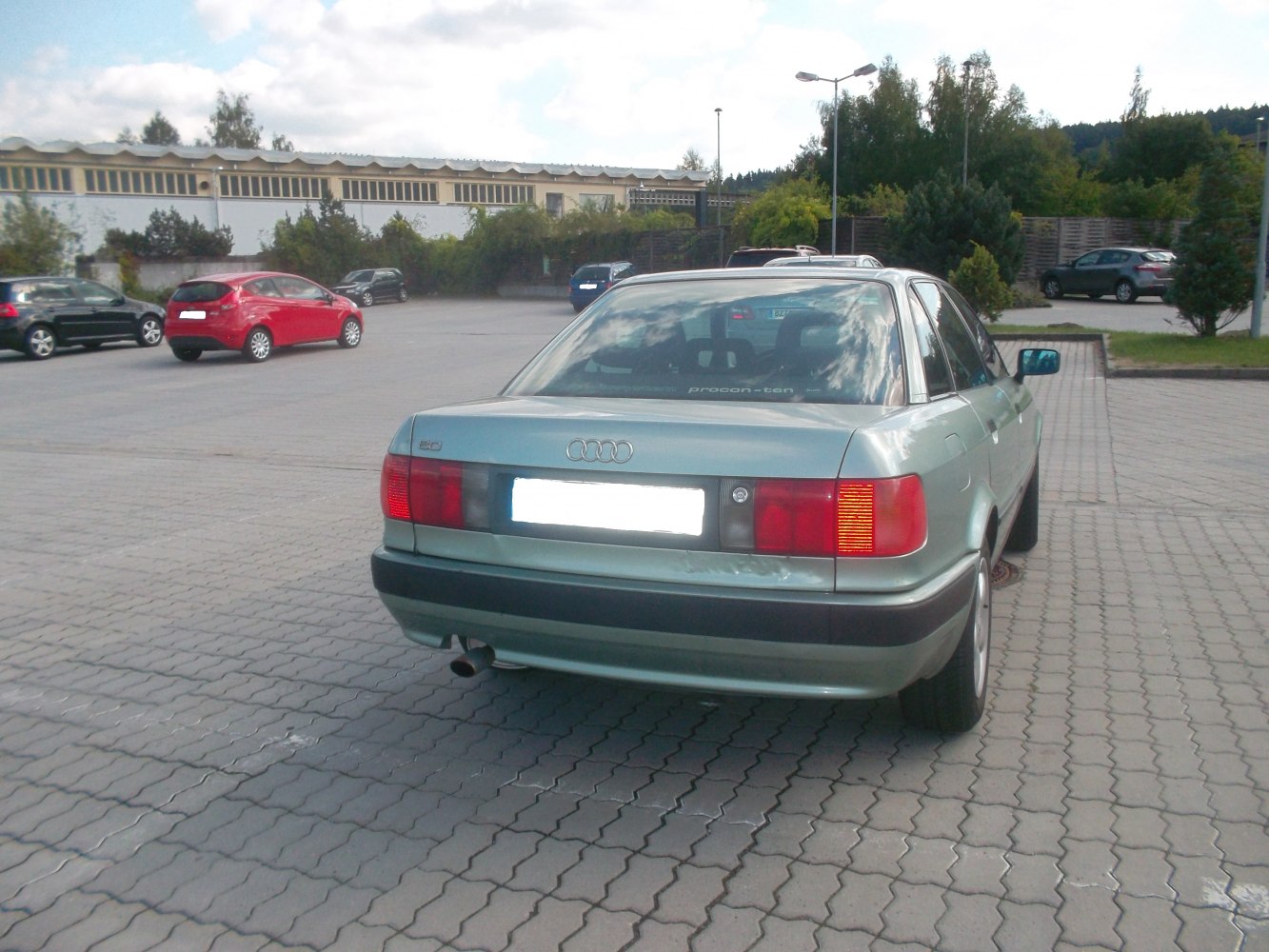 Rear view of a vintage sedan with distinctive tail lights and boxy design