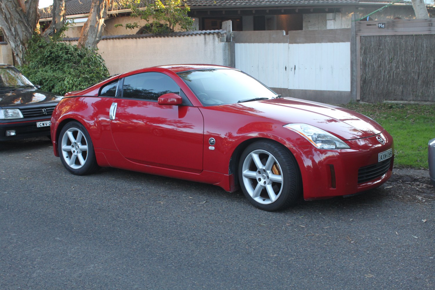 Sleek red sports coupe with alloy wheels and tinted windows