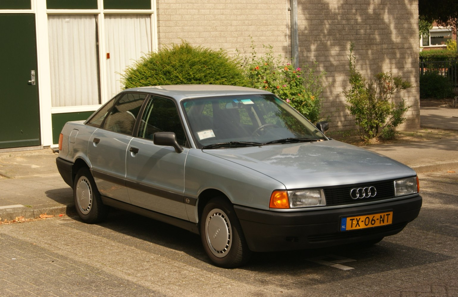 4-door sedan with rectangular headlights and black plastic bumpers