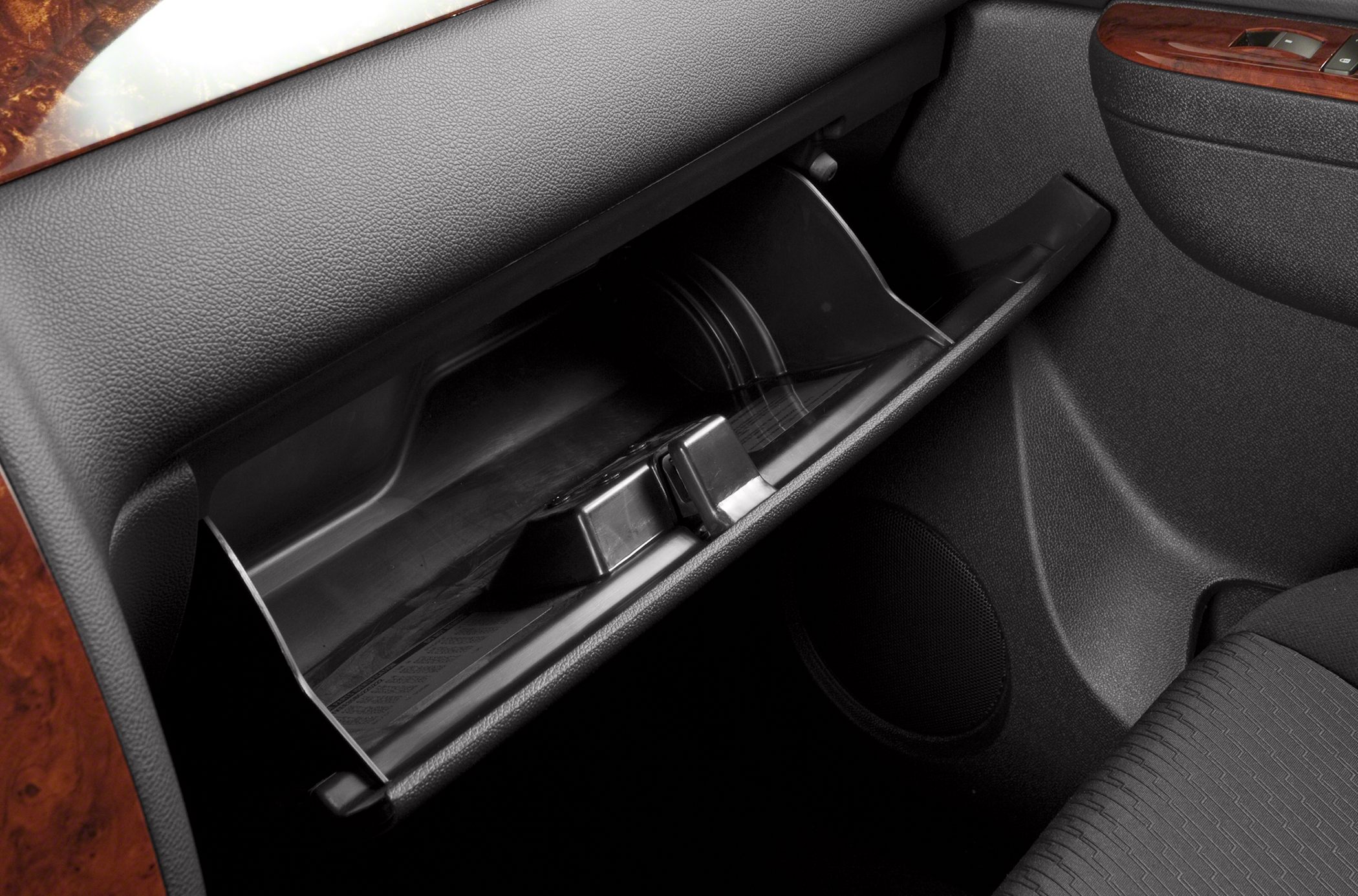 Open glove compartment with visible interior storage space and dashboard materials
