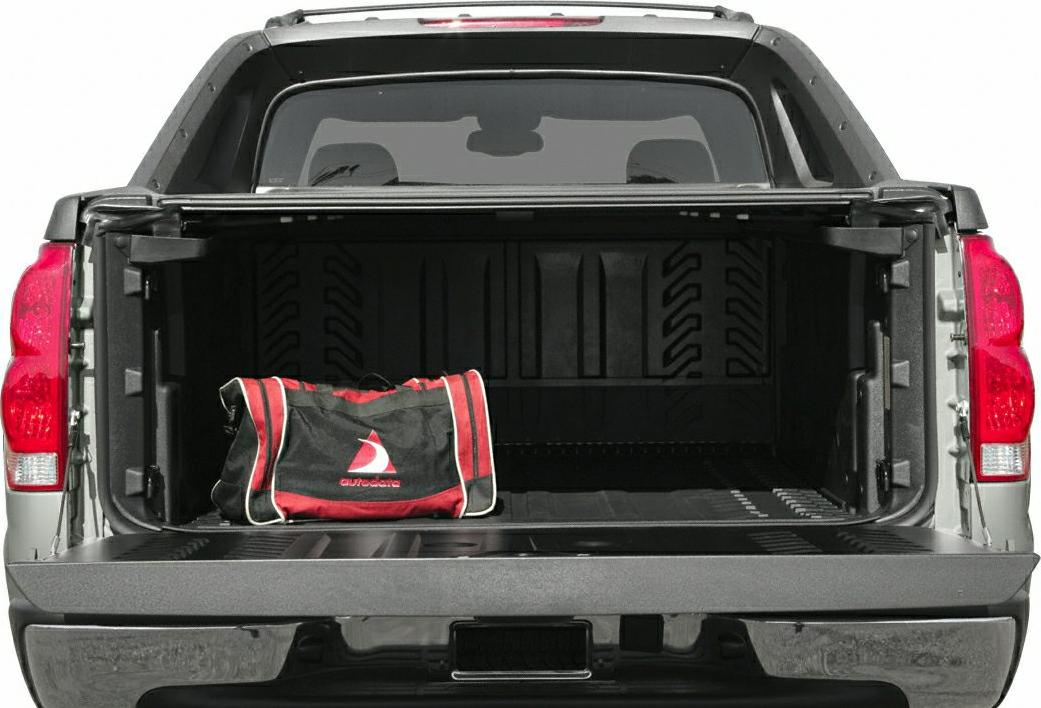 Pickup truck bed open with red-black cargo bag inside