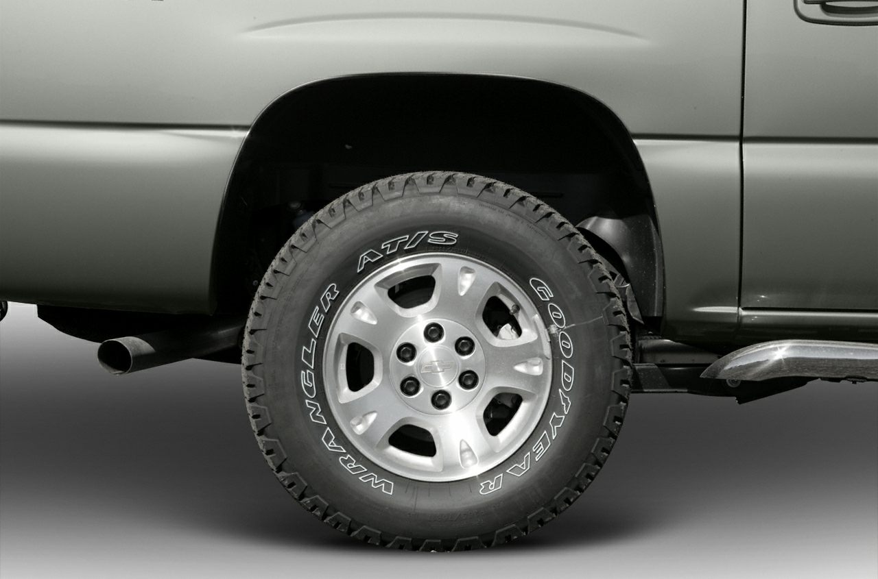 Close-up of alloy wheel with Goodyear Wrangler tire on vehicle rear.