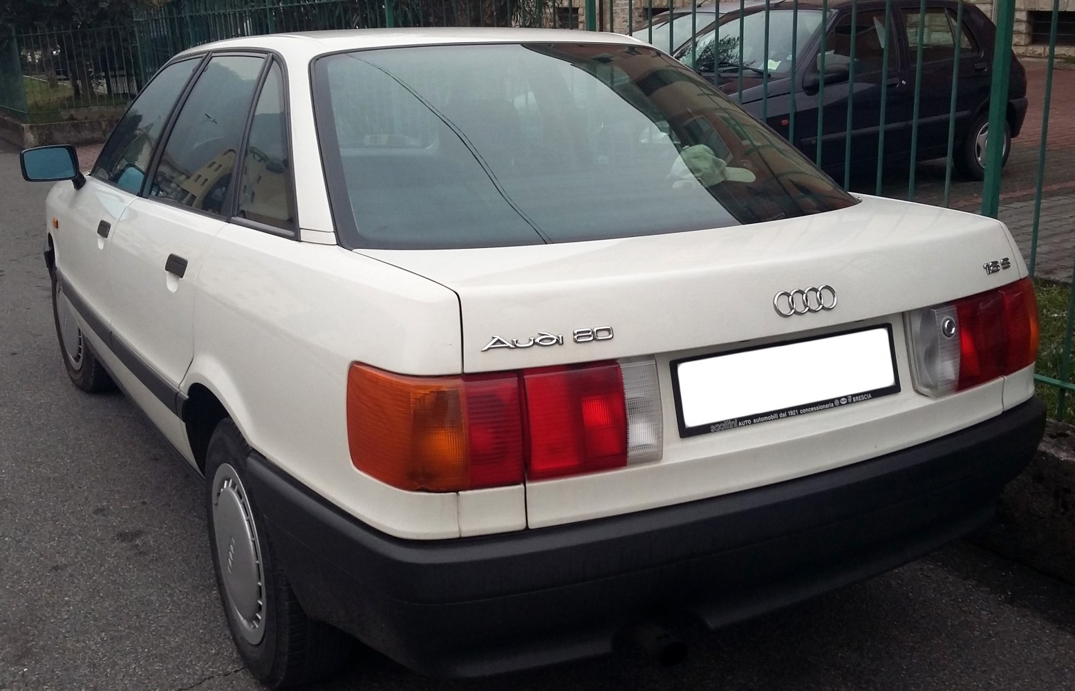 Rear view showing taillights and trunk of classic sedan