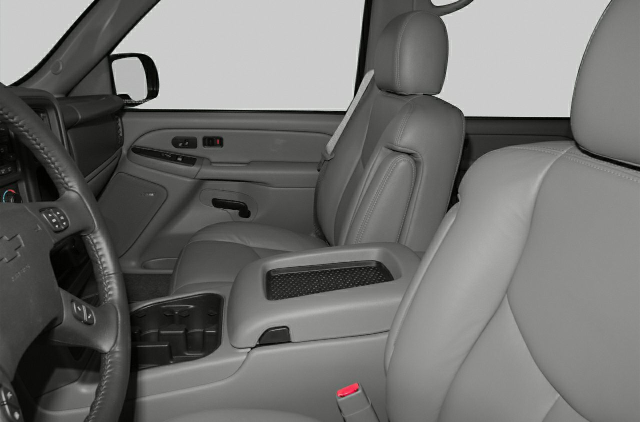 Front seats and center console interior with leather upholstery and seatbelt.