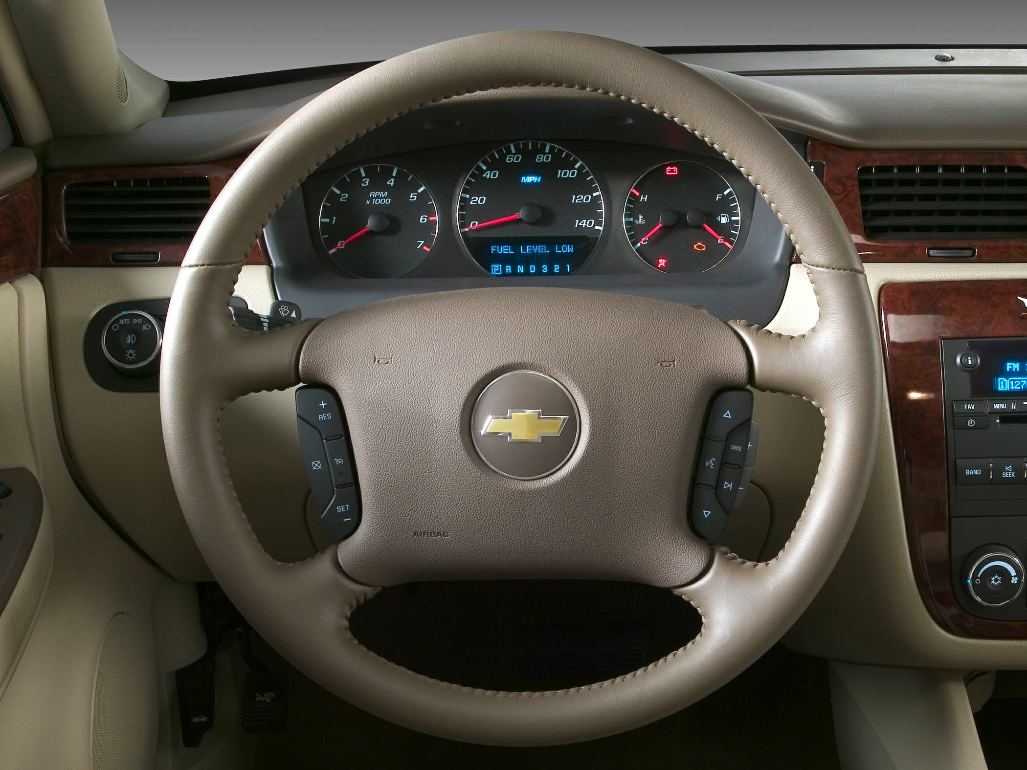 Steering wheel with instrument cluster and dashboard controls.