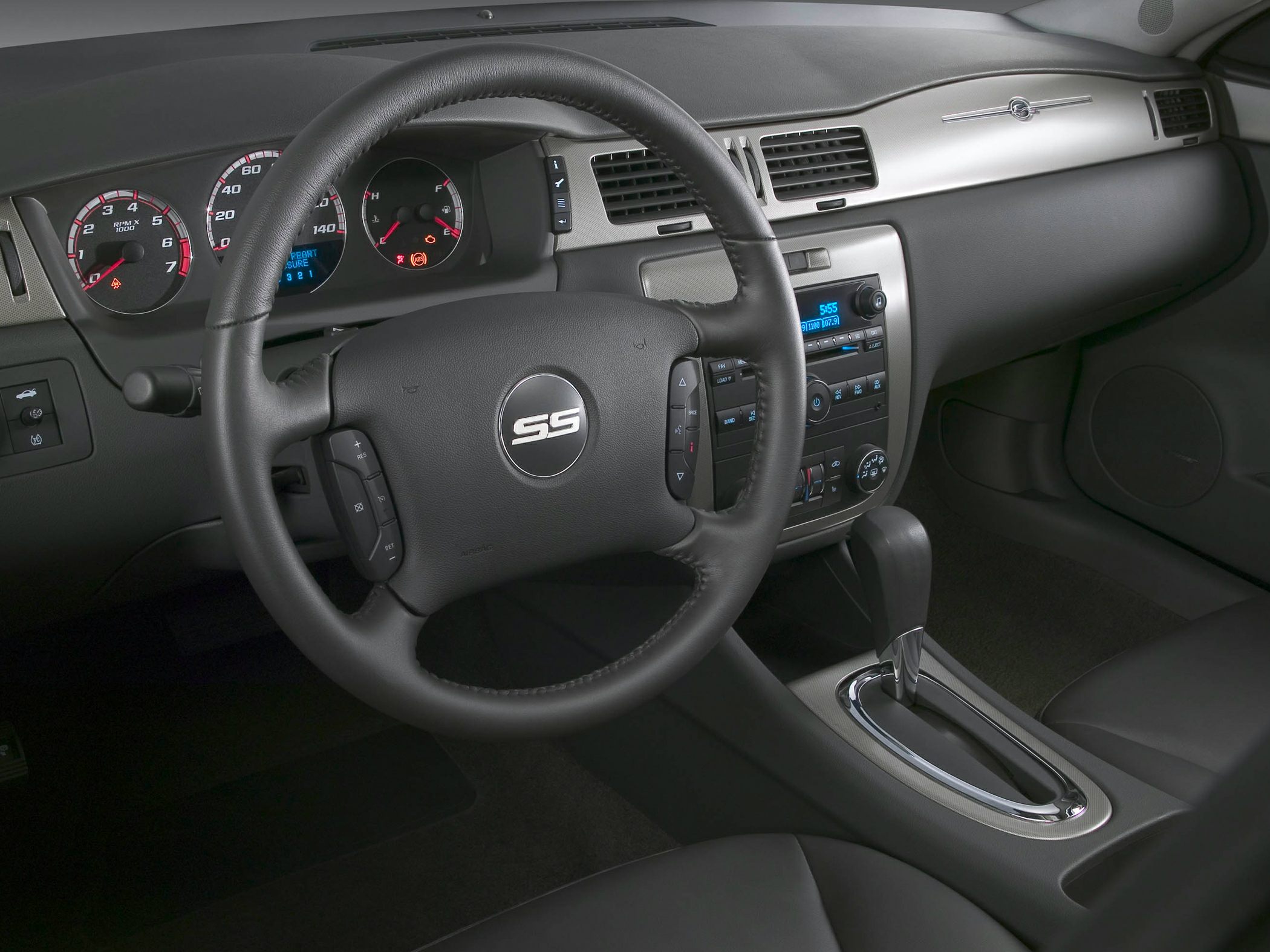 Steering wheel with SS logo and dashboard controls in a car interior