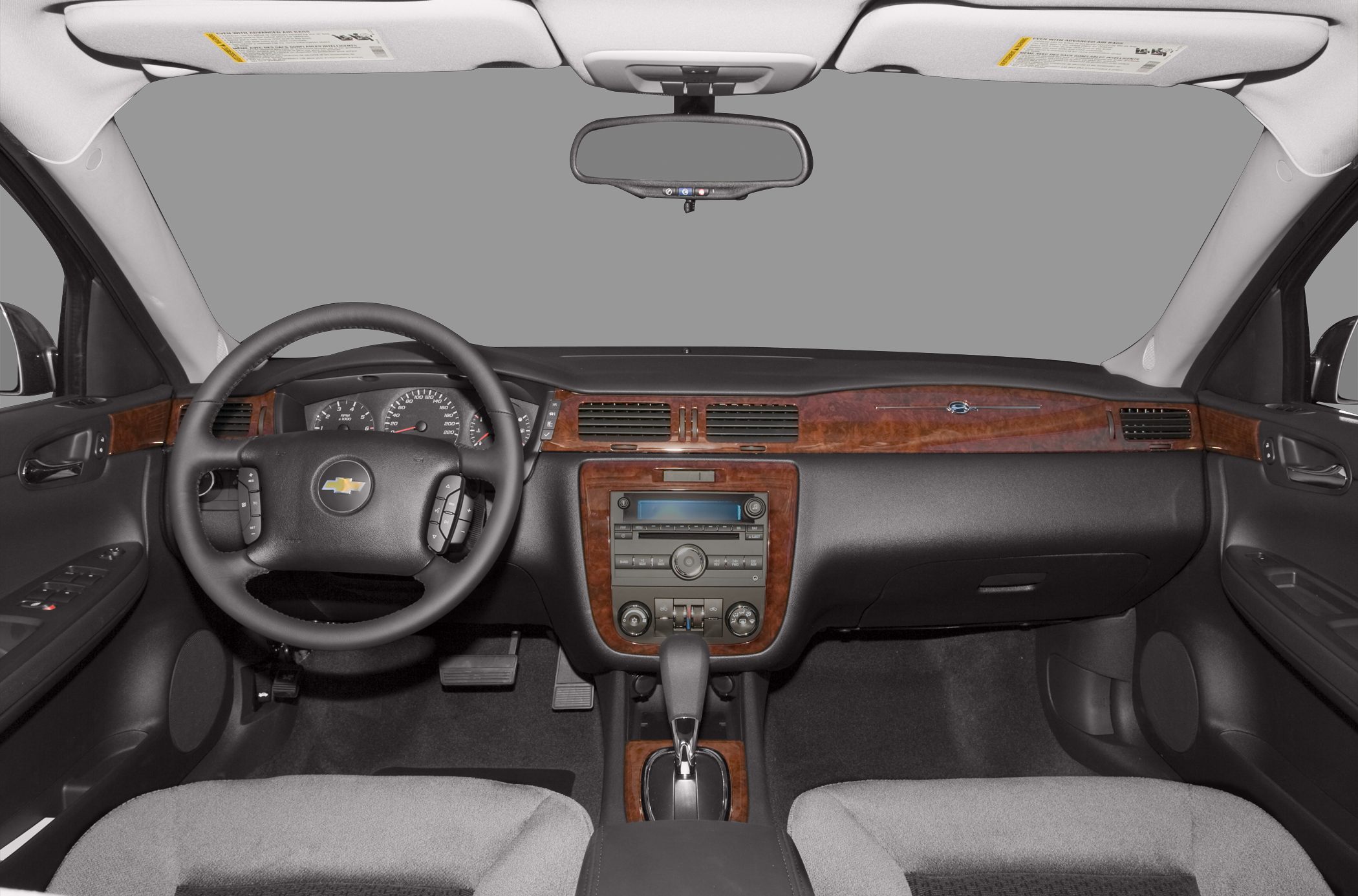Dashboard and steering wheel with wood trim and control layout