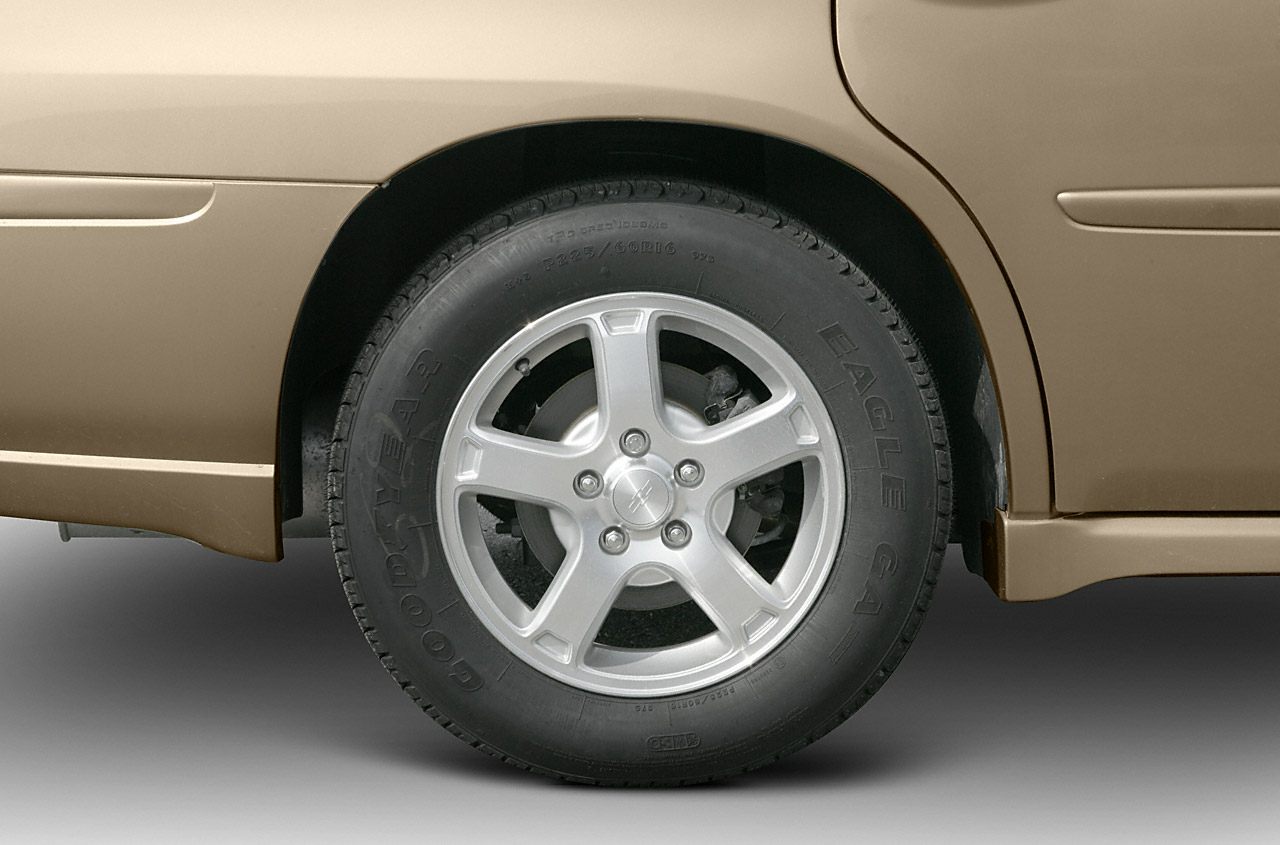 Alloy wheel with Goodyear Eagle tire on vehicle's rear side.