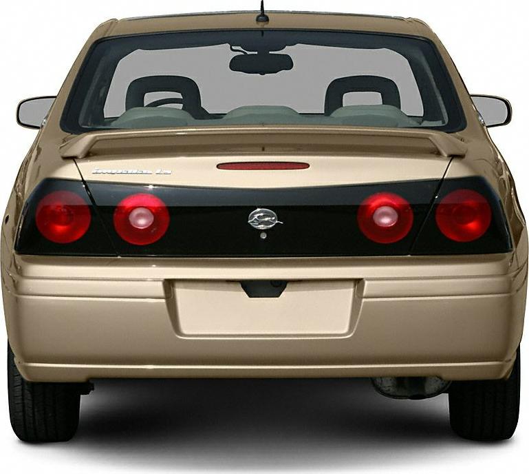 Rear view with round red tail lights and black trim panel