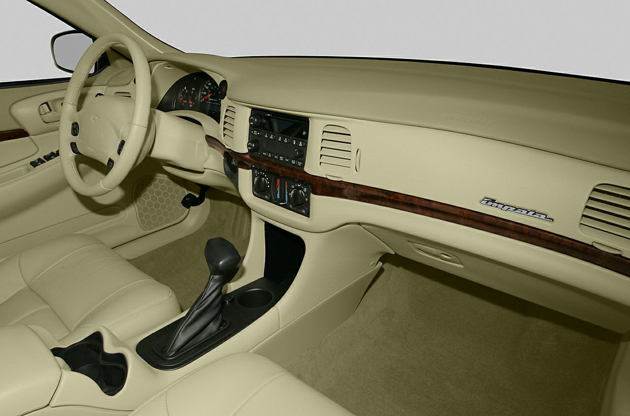 Beige interior with dashboard, steering wheel, and wood trim