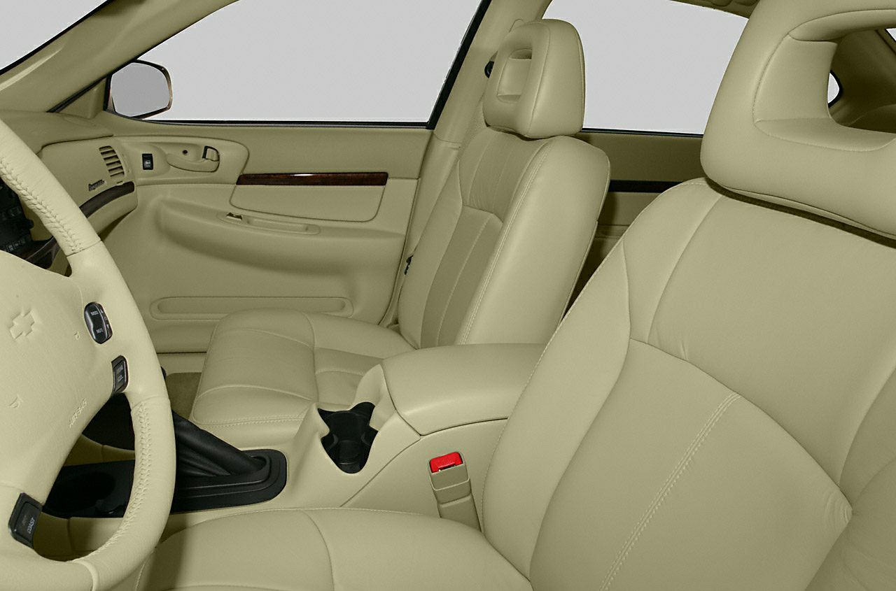 Beige leather front seats and door panel with armrest and controls
