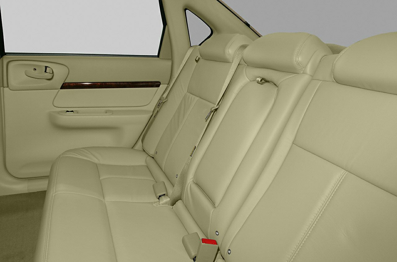 Beige leather rear seats with seatbelts and door panel