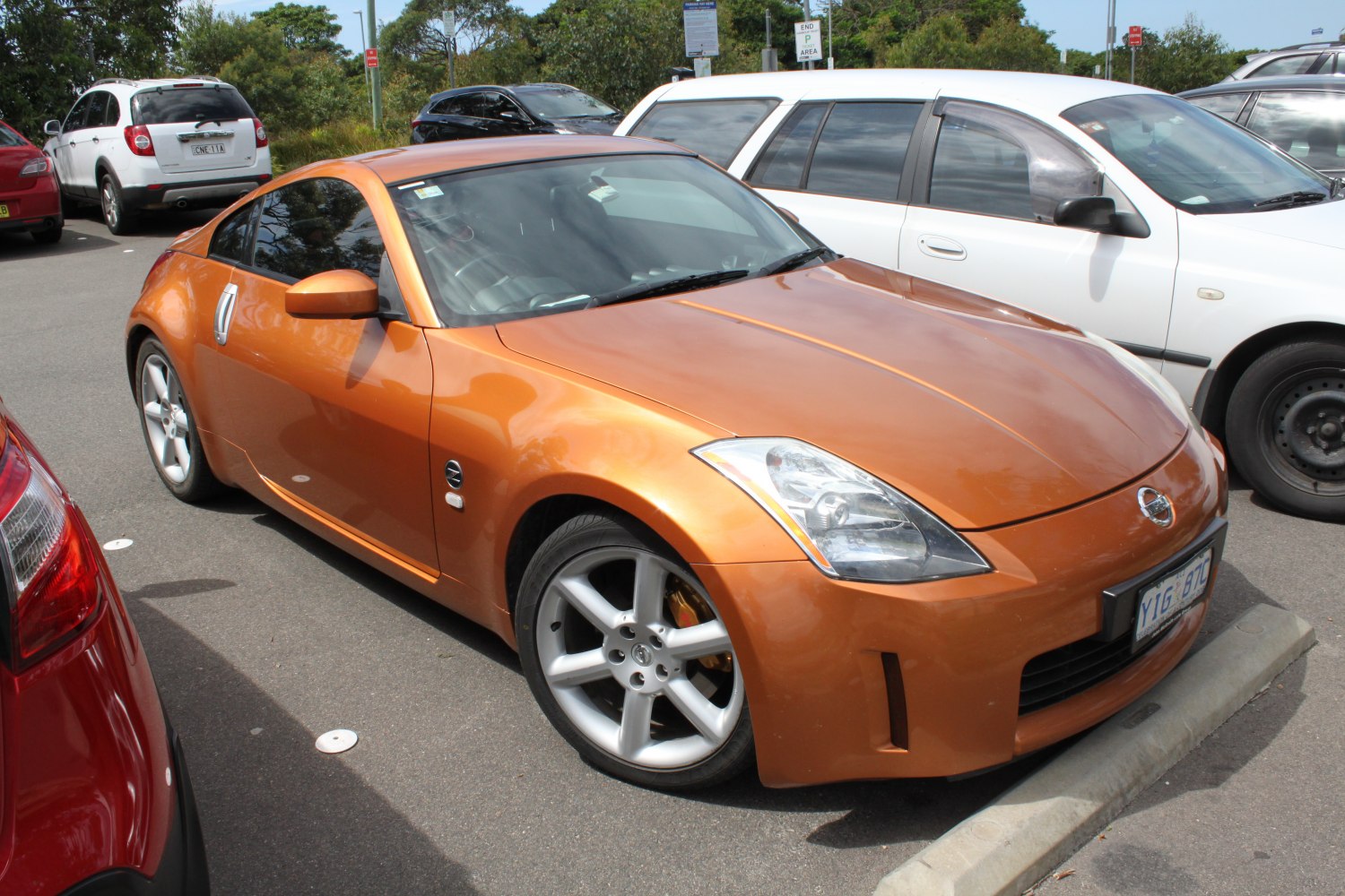 Orange sports coupe with alloy wheels and angular headlights