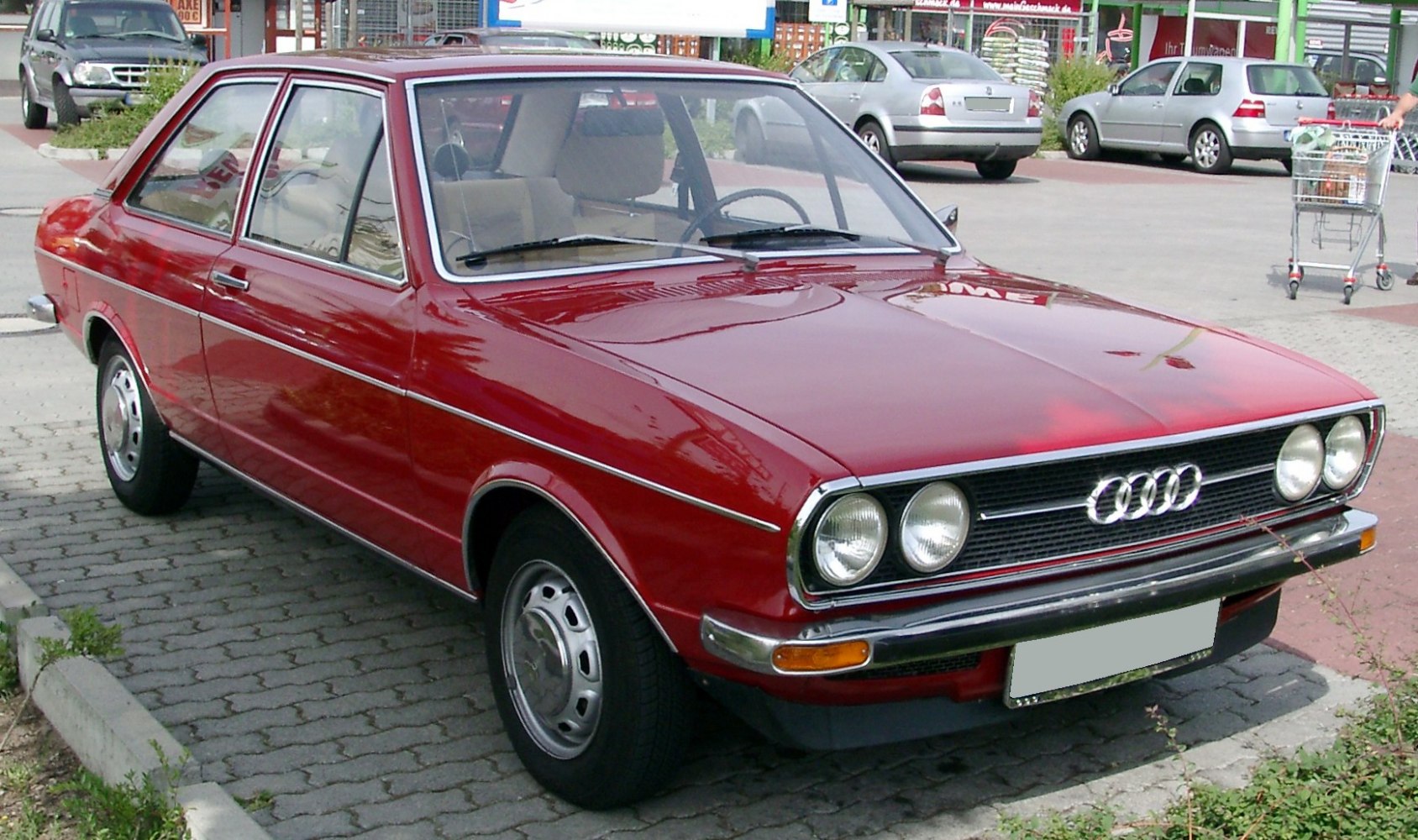 Dual round headlights, chrome trim, classic early 70s sedan design