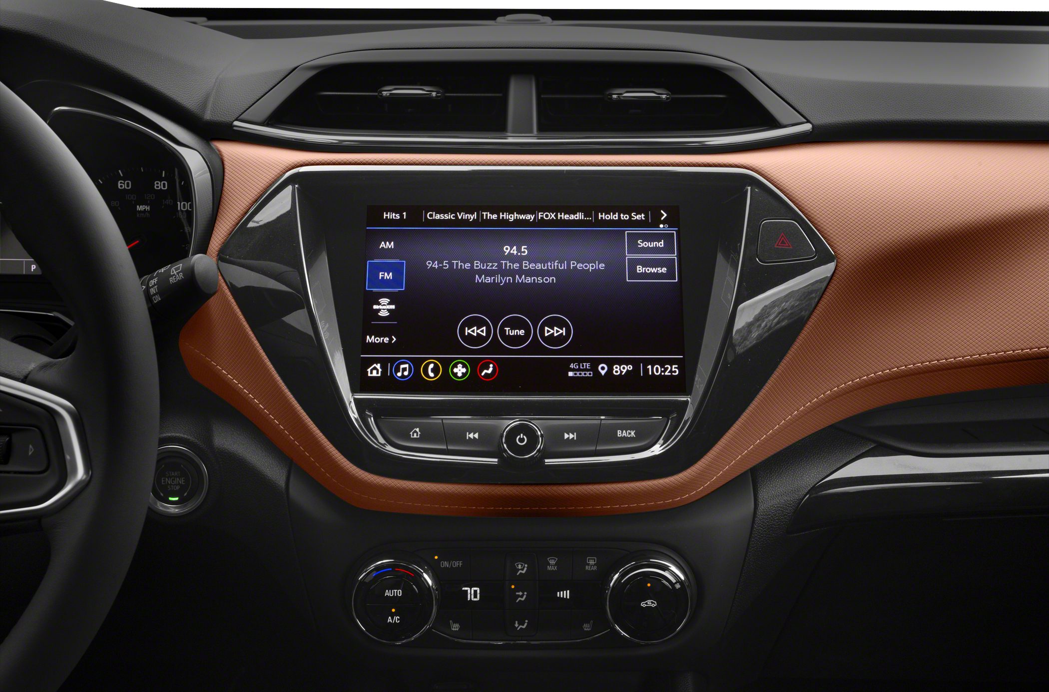 Infotainment touchscreen and climate control on a textured dashboard panel