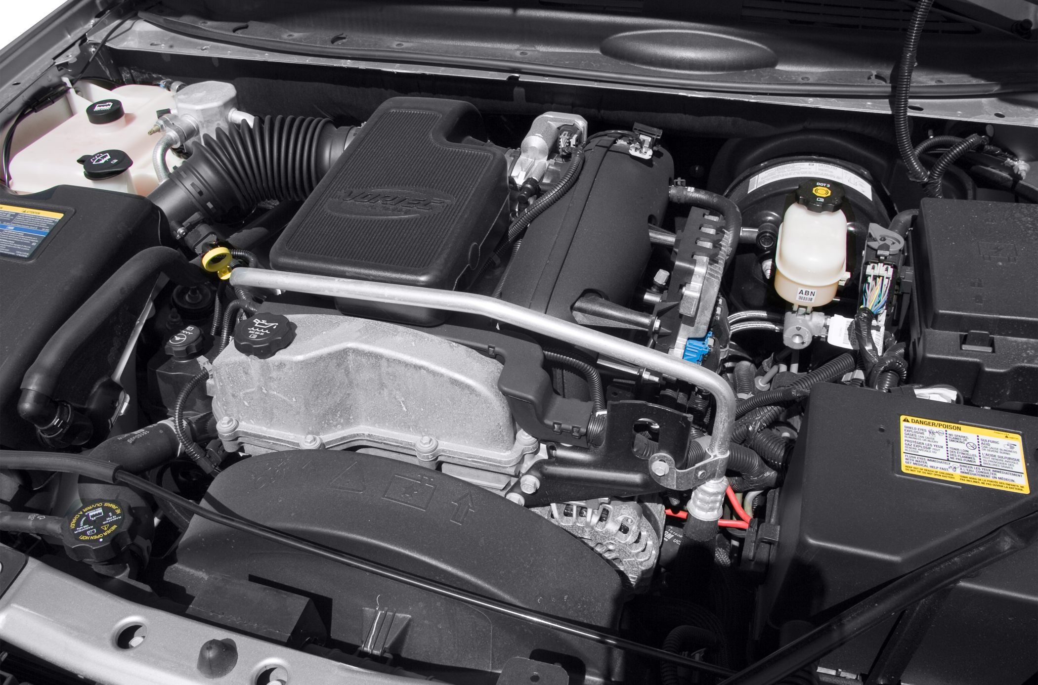 Engine bay with air intake, fluid reservoirs, and wiring harness
