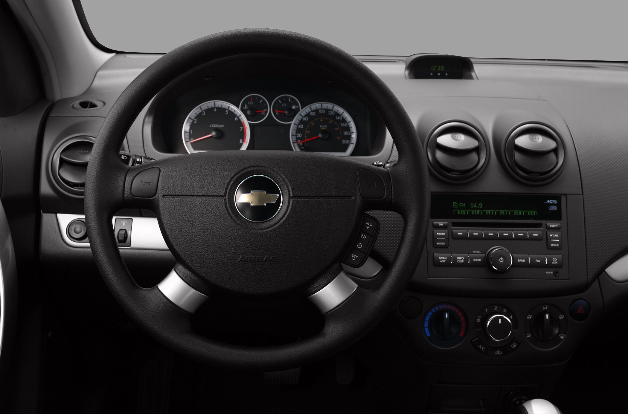 Interior dashboard with steering wheel, instrument cluster, and center console controls