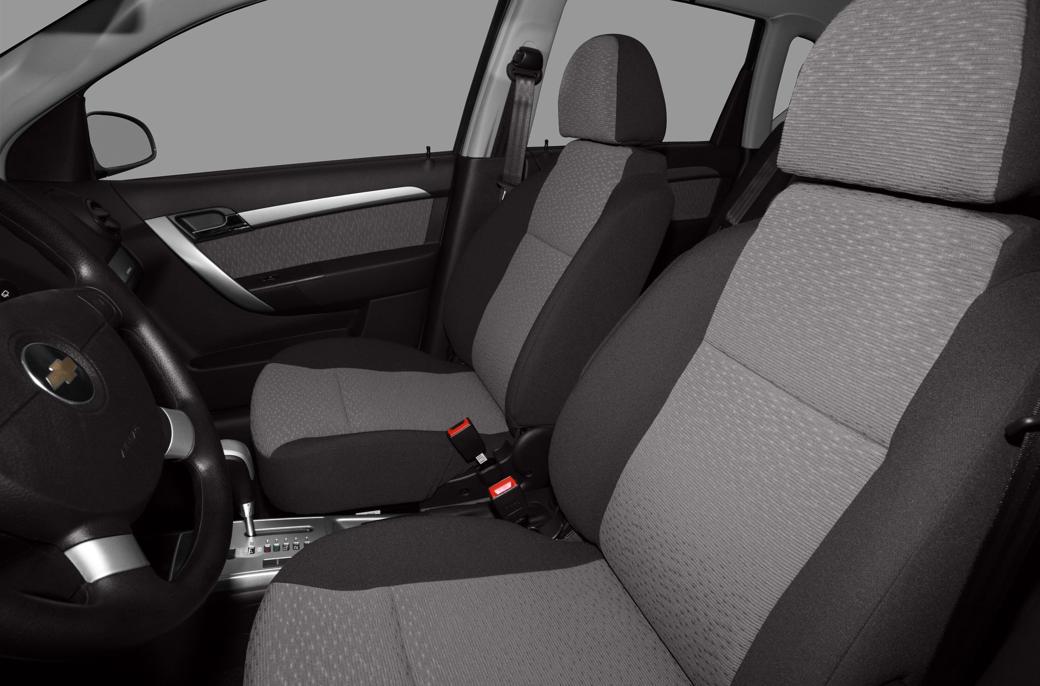 Front seats with fabric upholstery and adjacent door panel in vehicle interior