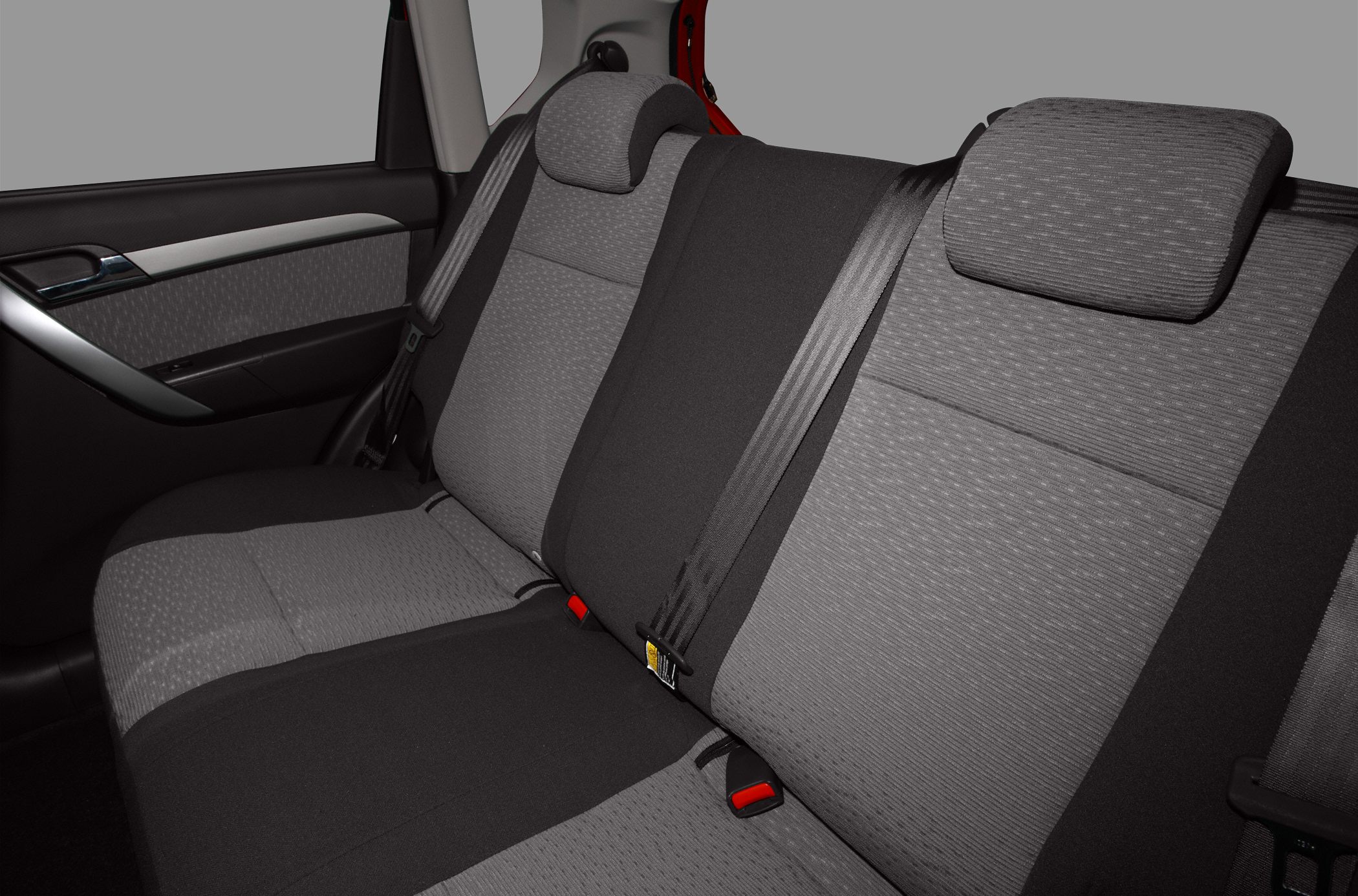 Rear passenger seats with fabric upholstery and seatbelts