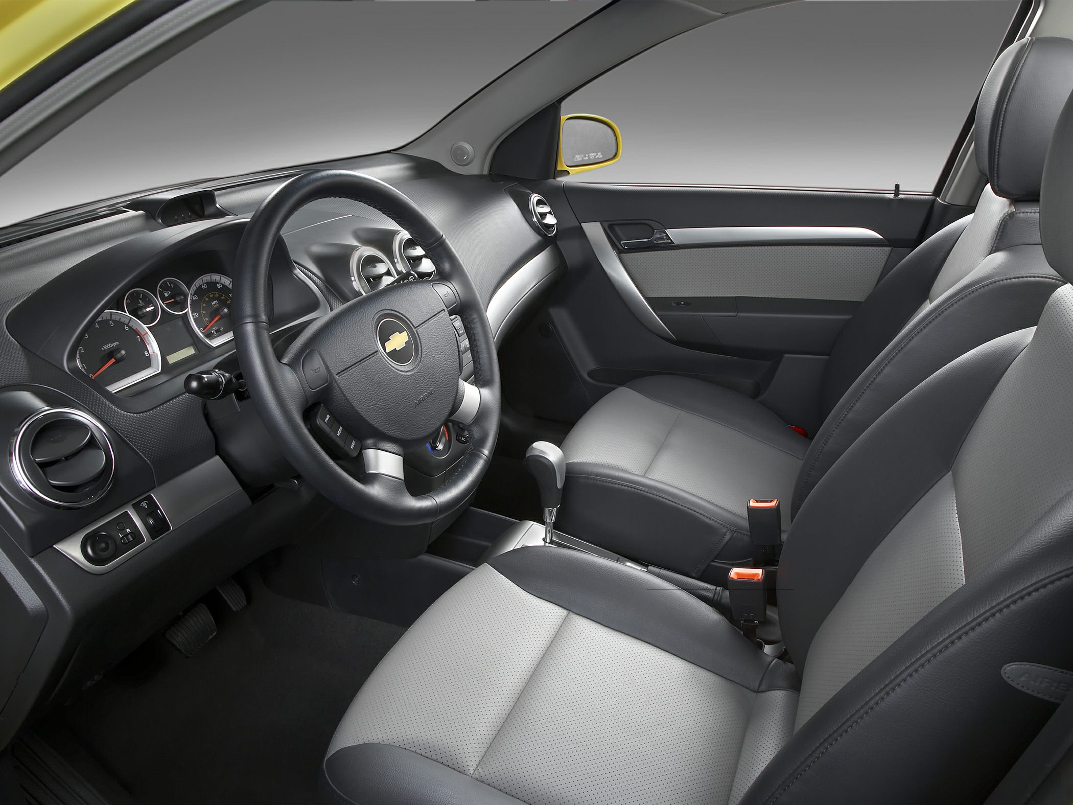 Ergonomic dashboard and modern two-tone seating with leather and fabric combination.