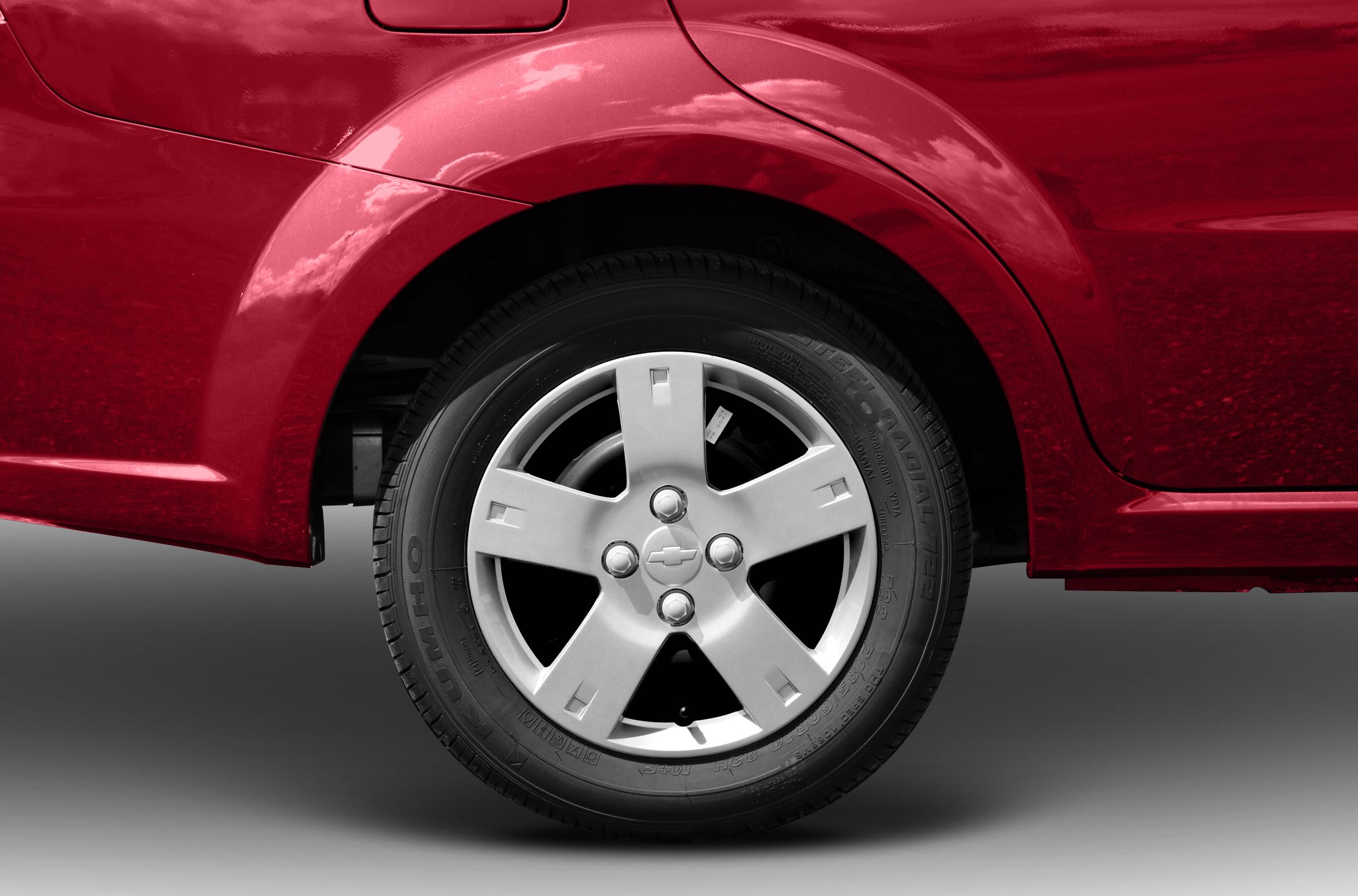 Close-up of alloy wheel and rear fender of a red vehicle