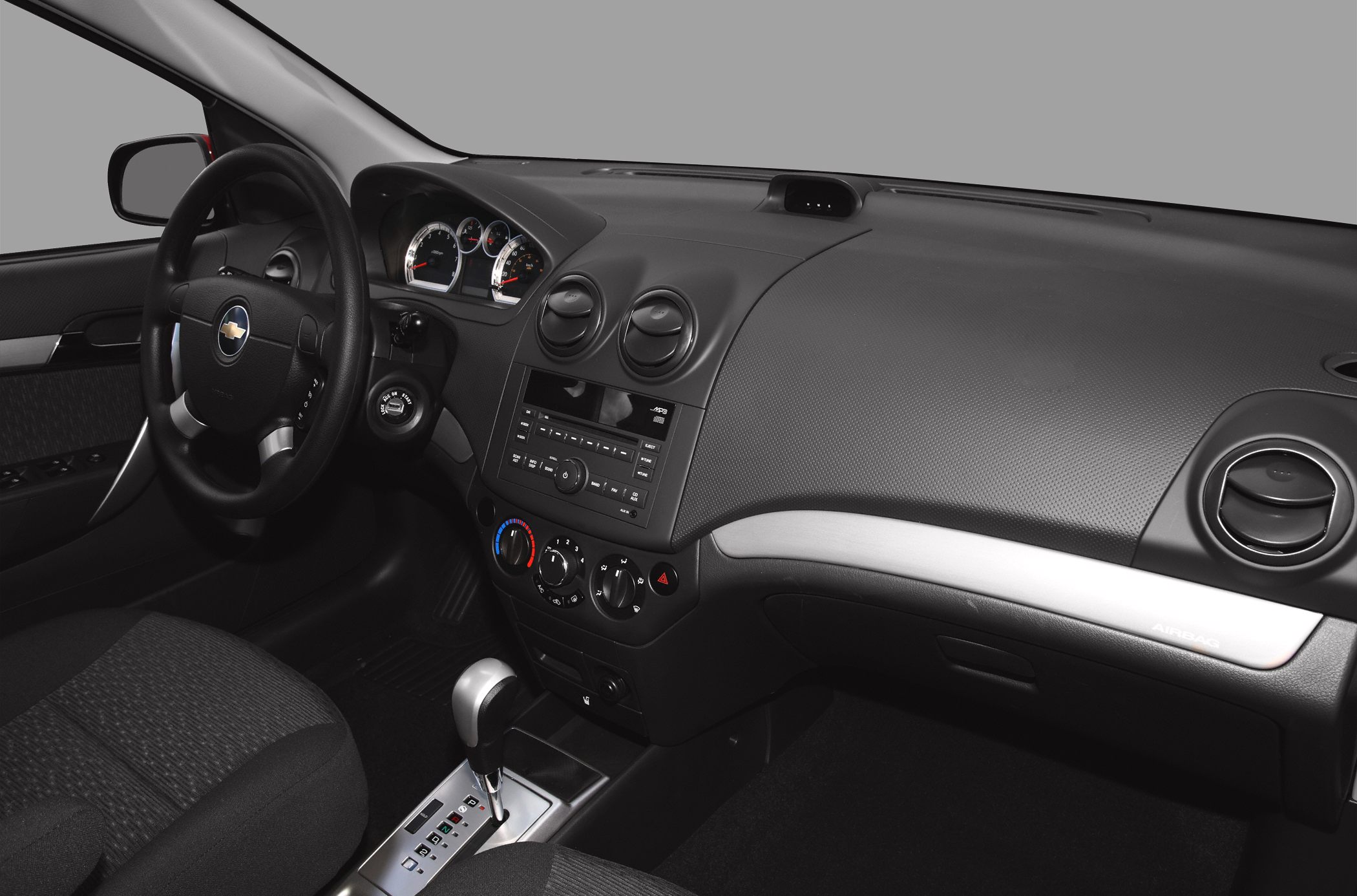 Dashboard, steering wheel, climate controls, gear shift in car interior