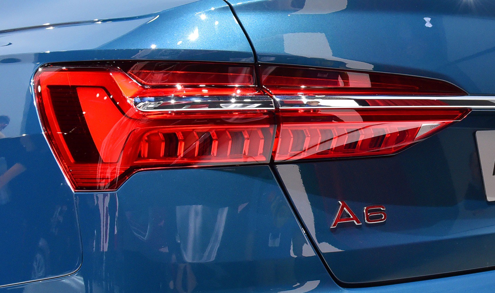 Rear tail light and A6 badge on blue vehicle