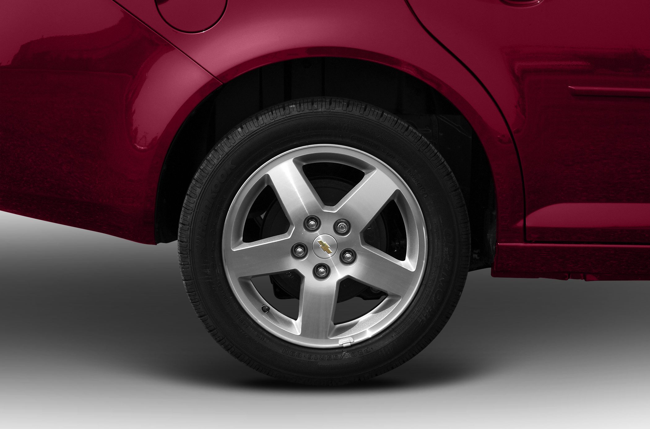 Close-up of a five-spoke alloy wheel and tire.