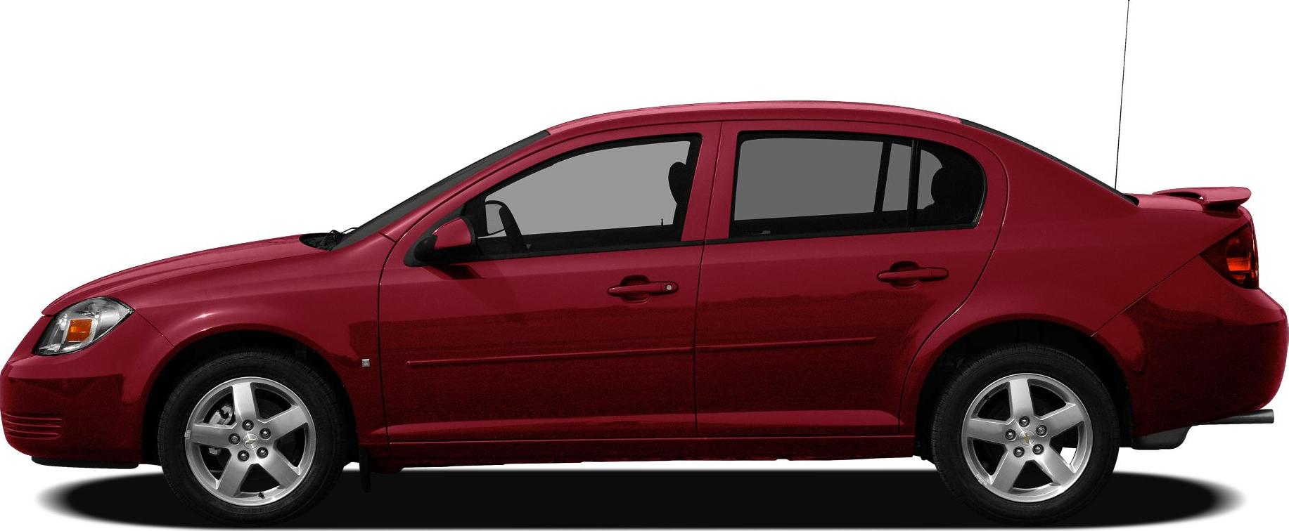 Side view of a red compact sedan with sporty rear spoiler and alloy wheels.