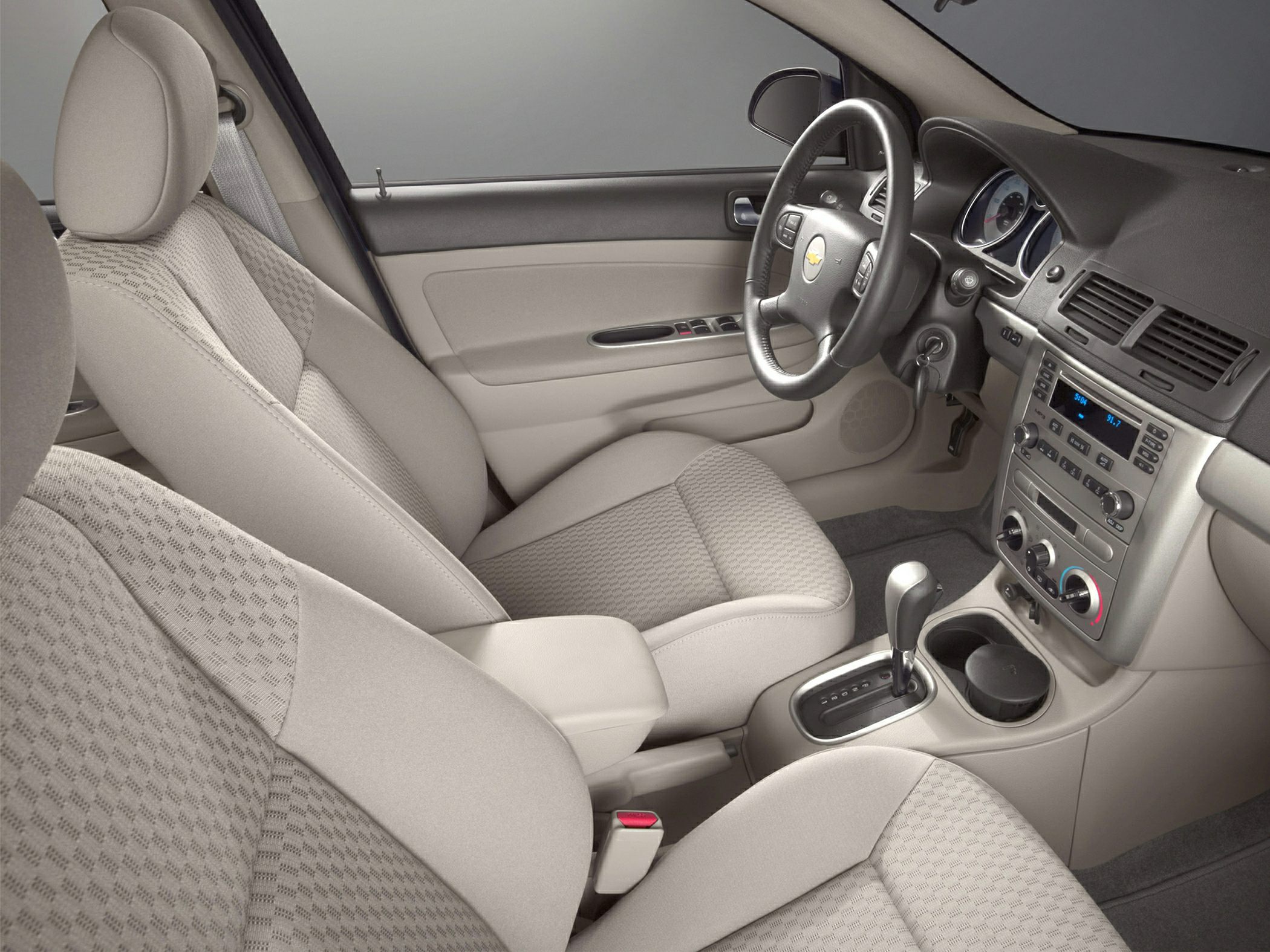Front interior view showing dashboard, steering wheel, and fabric seats