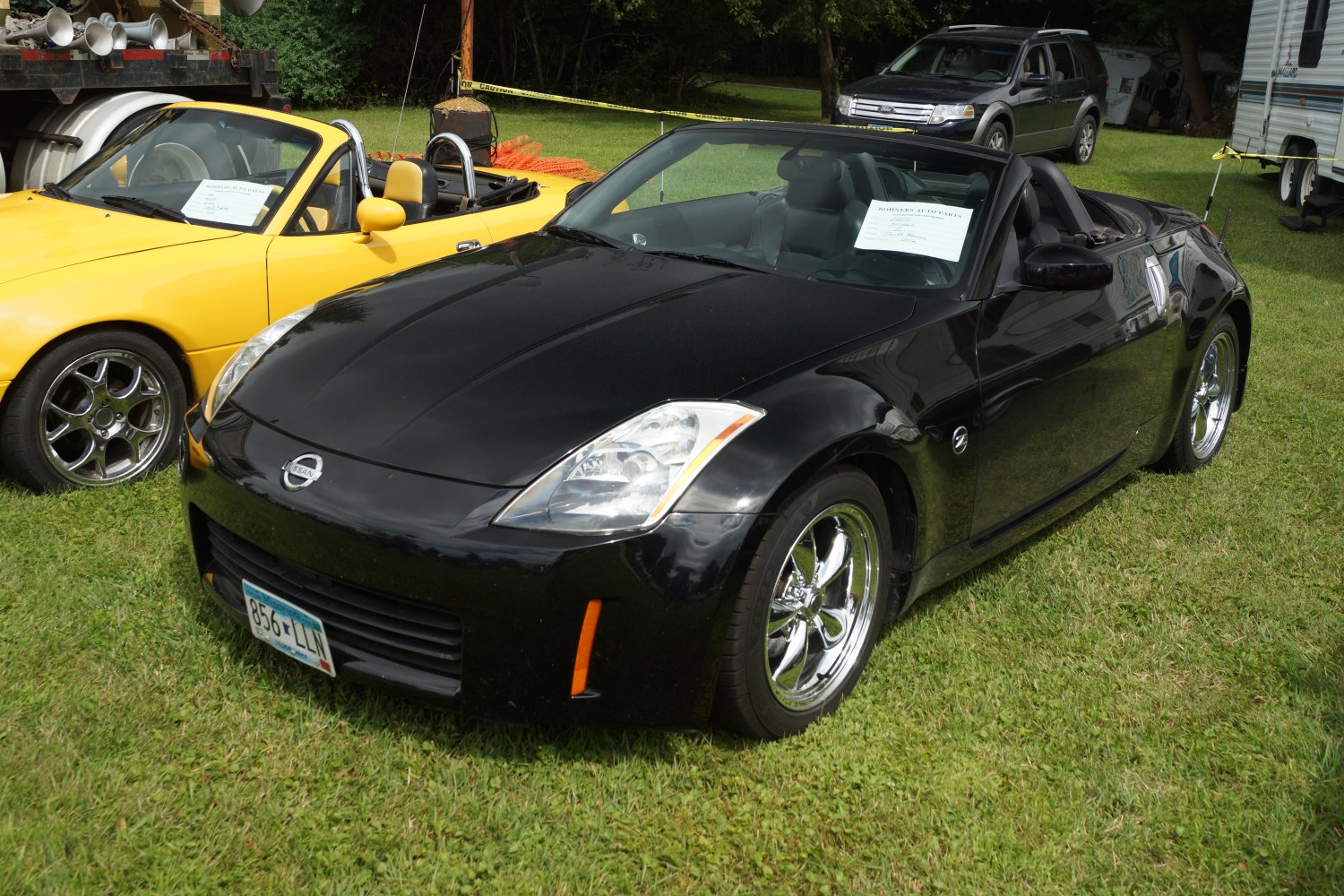 Black convertible roadster with chrome wheels and sleek body design