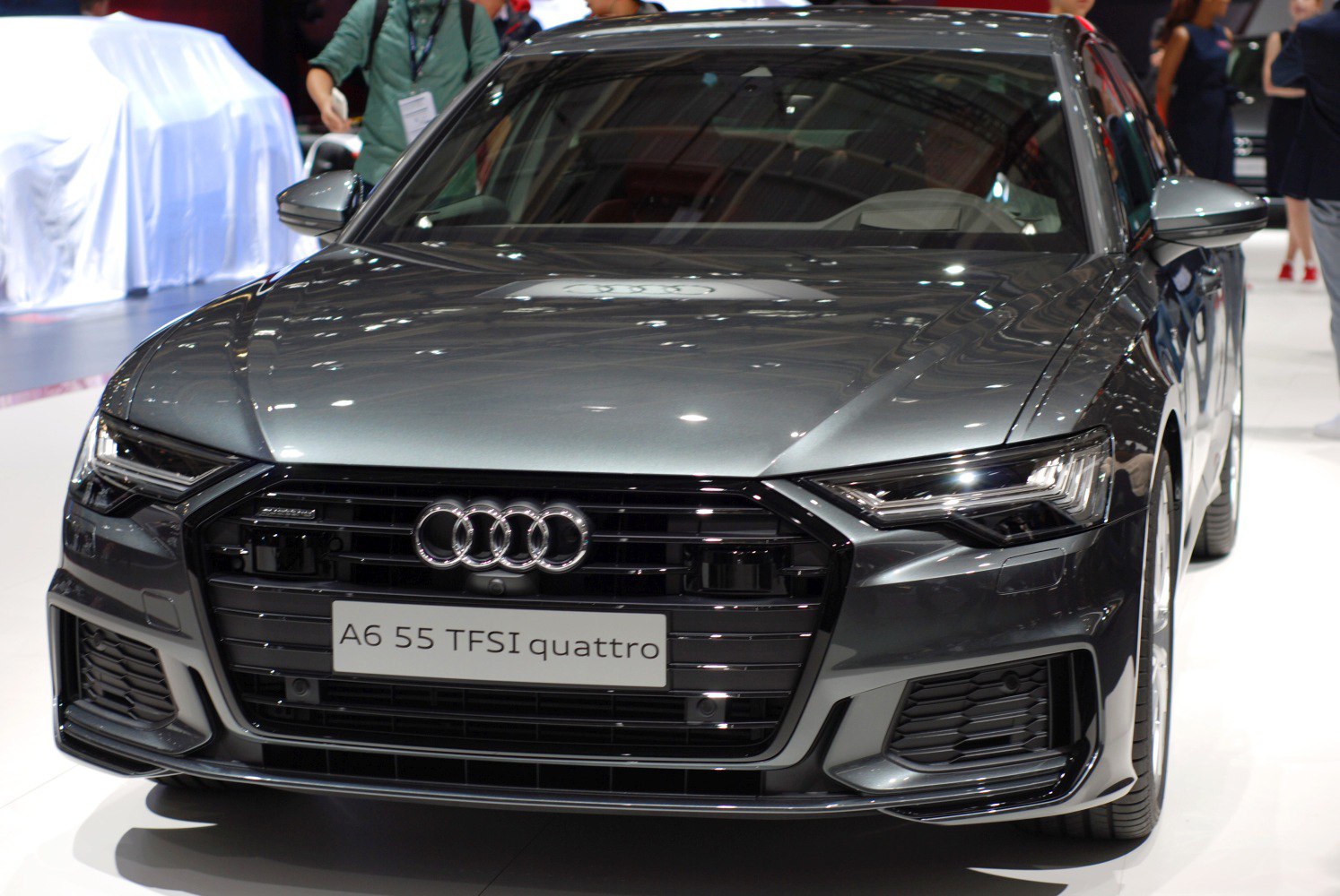 Front view of luxury sedan showing LED headlights and bold grille.