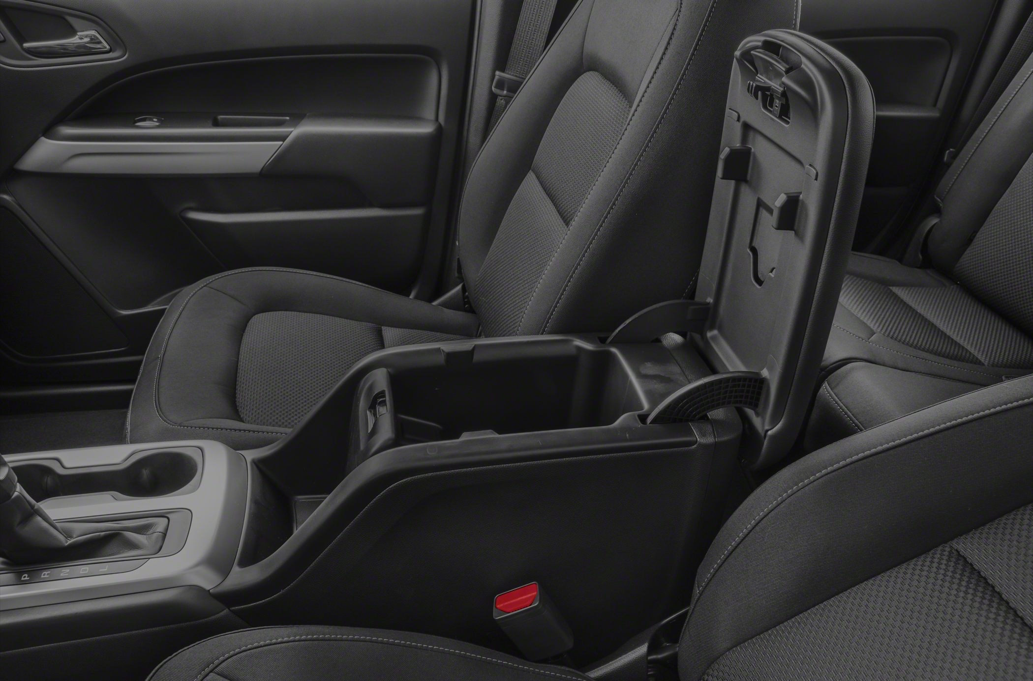 Center console storage compartment with front seats upholstery and door panel details